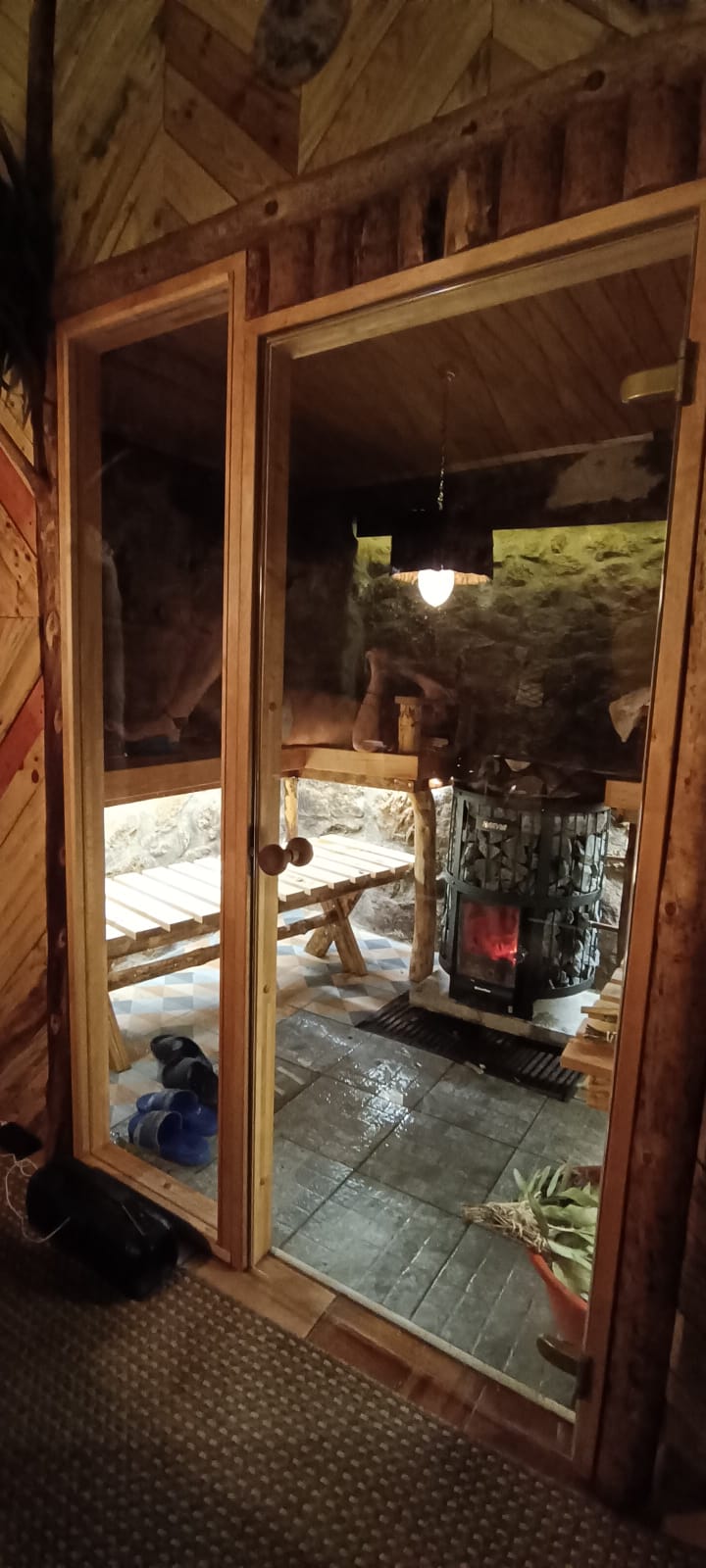 Sauna doorway with warm firelight beyond